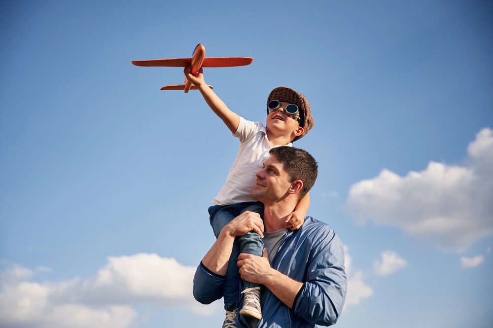 Playing,With,Toy,Plane,,Sitting,On,The,Shoulders.,Father,And